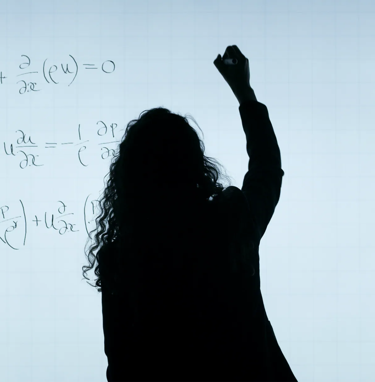 Silhouette of a person writing equations on a whiteboard