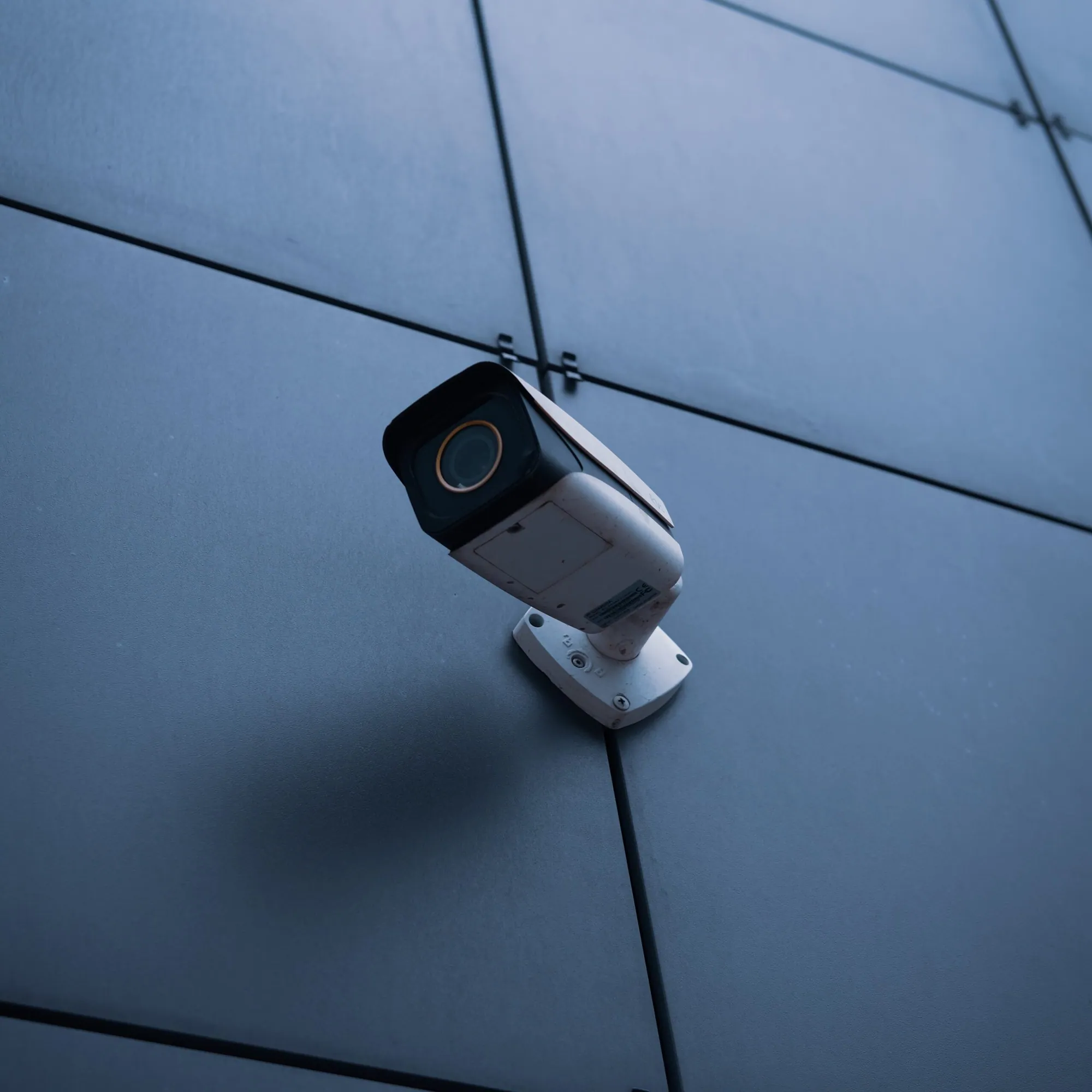 Security camera on a dark wall