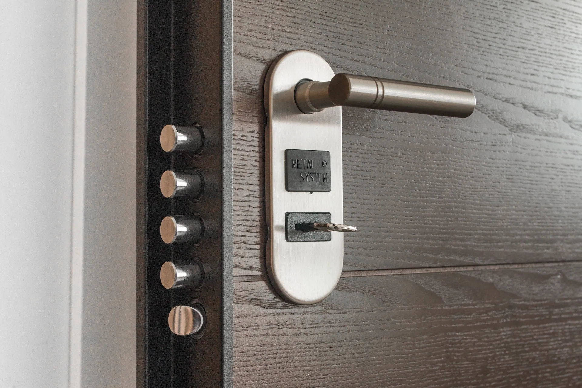 Door handle with a keypad lock on a wooden door