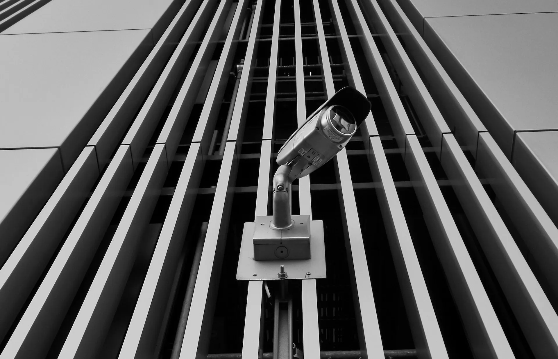 Security camera against a building with metal slats