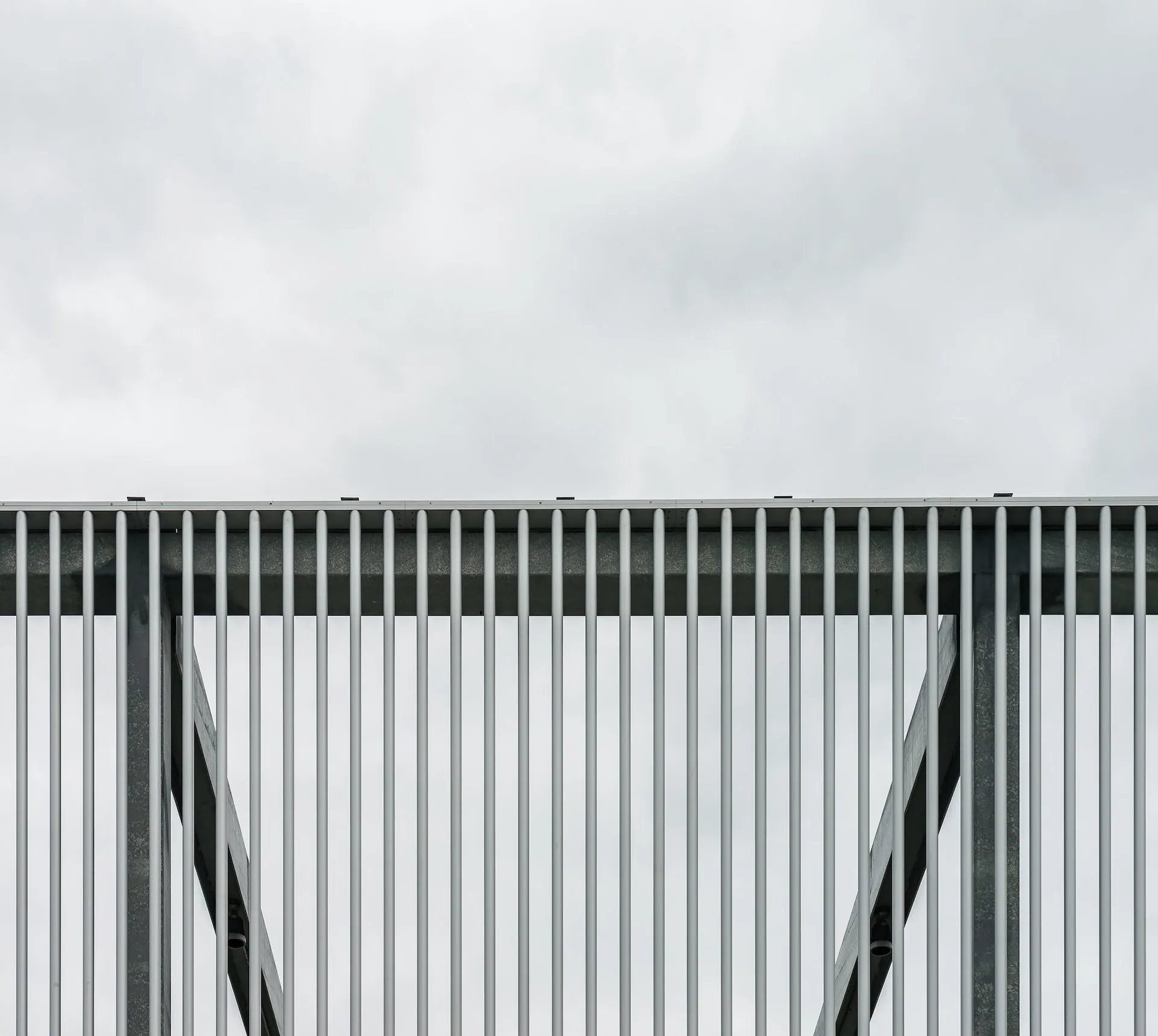 Metal building structure against a cloudy sky