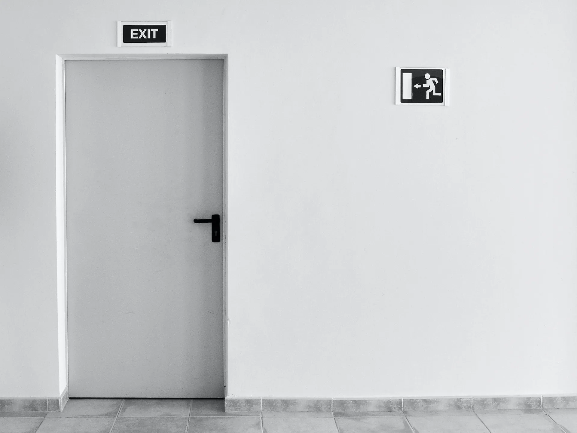 Emergency exit door in a white wall