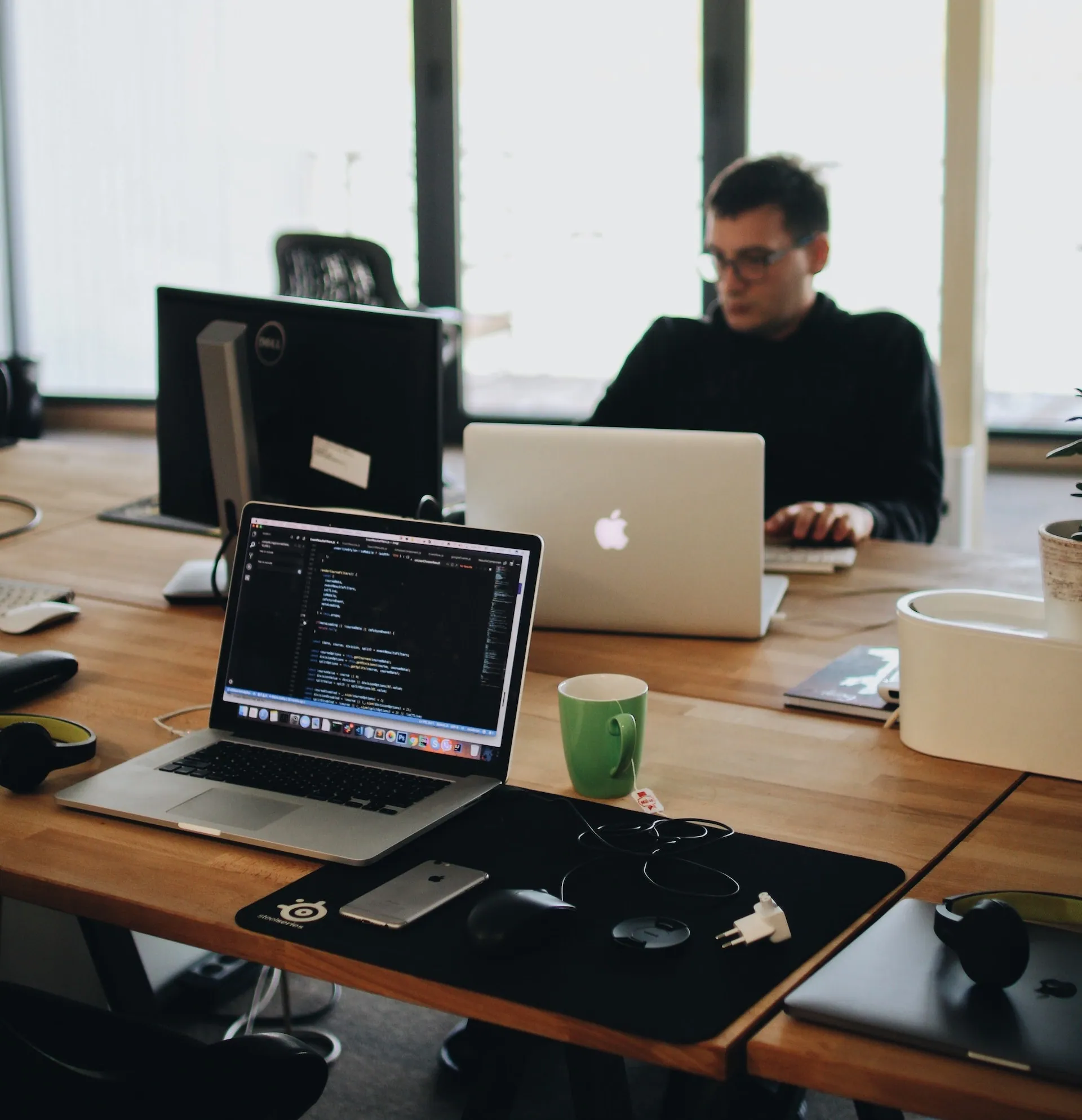 People working at laptops in an open-plan office