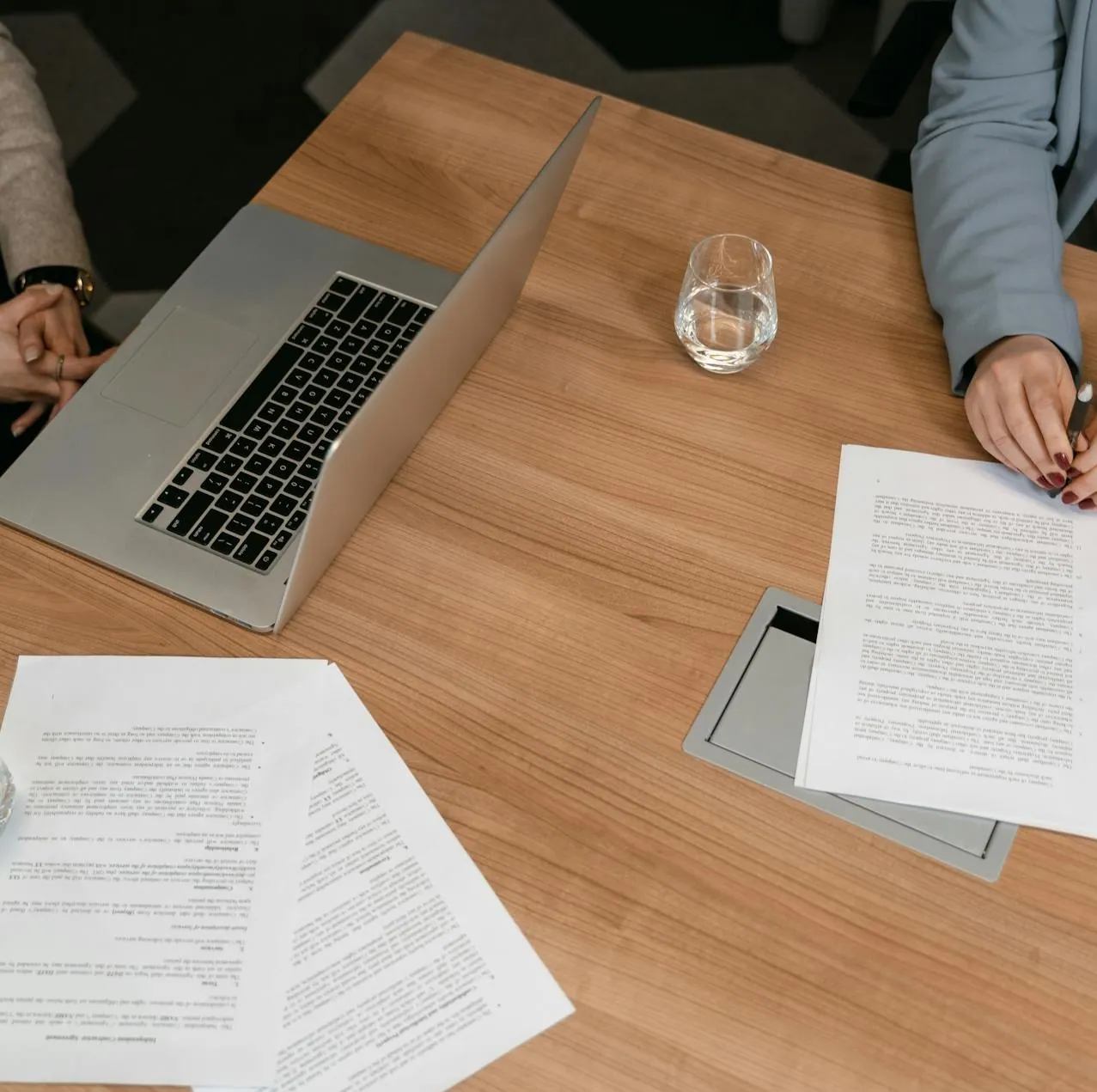 Laptop and printed documents on a meeting table
